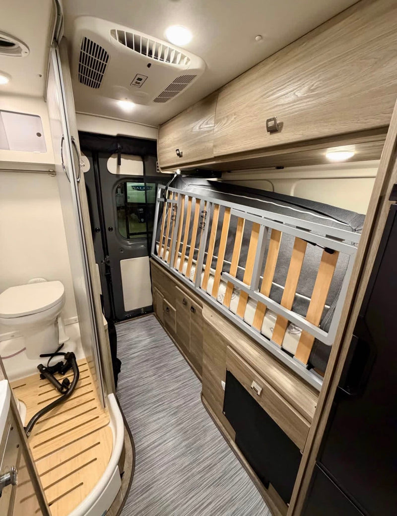  and a mounted TV.|Modern rv rental camper van interior featuring a compact kitchen with sink — photo 9