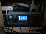 Portable power station installed in an RV rental, providing off-grid power via its display and multiple ports for camping.