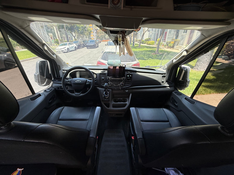 Inside an RV rental van: driver's view of the dashboard, steering wheel, and a sunny street through the windshield. — photo 5