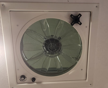 This RV rental features a ceiling vent fan with a protective screen, speed controls (L, M, H, OUT), and a fuse for fresh airflow.
