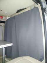RV rental interior: A grey privacy curtain is drawn across the back of the mobile living space, offering shade and seclusion.