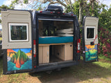 Open rv rental campervan showcasing custom interior with bed & cabinetry, plus vibrant rear door art. Ready for adventure!