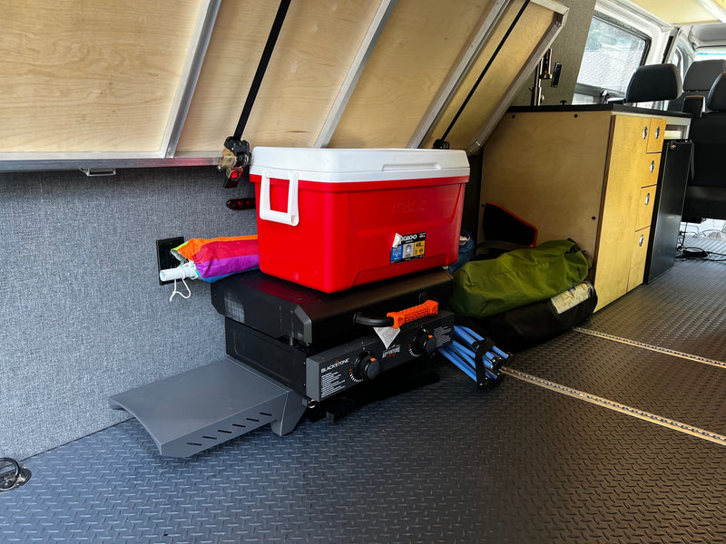  parked on a driveway with unique contour graphics.|Inside an rv rental van: view from the side door shows black front seats — photo 18