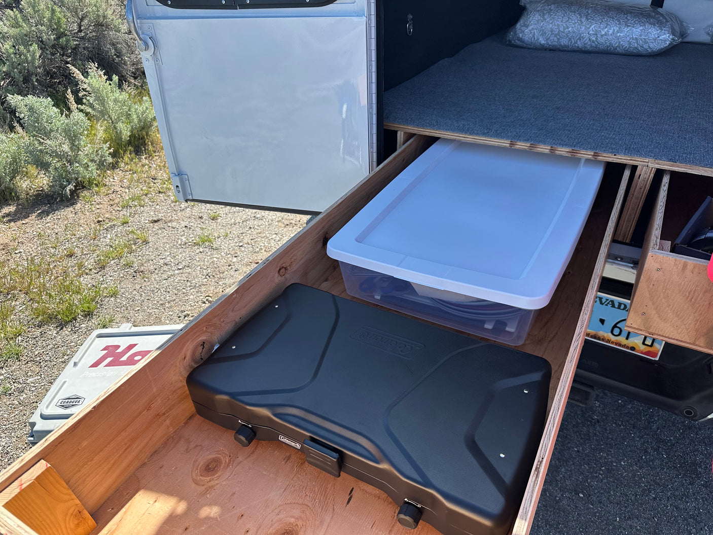RV rental camper kitchen drawer with Coleman stove & storage. Ready for road trip cooking & adventure!