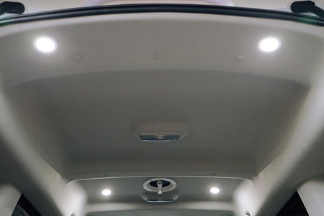 Overhead view of an RV rental interior, showcasing integrated LED ceiling lights and a central ventilation fan.