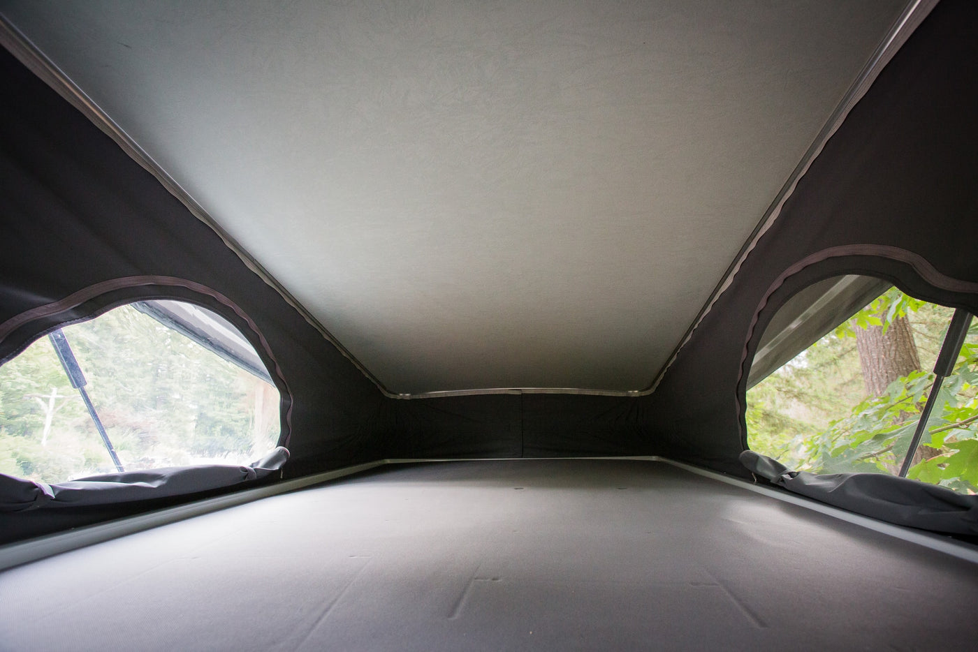  and a nature view through screened rear doors.|Cozy RV rental interior showing a bed — photo 13