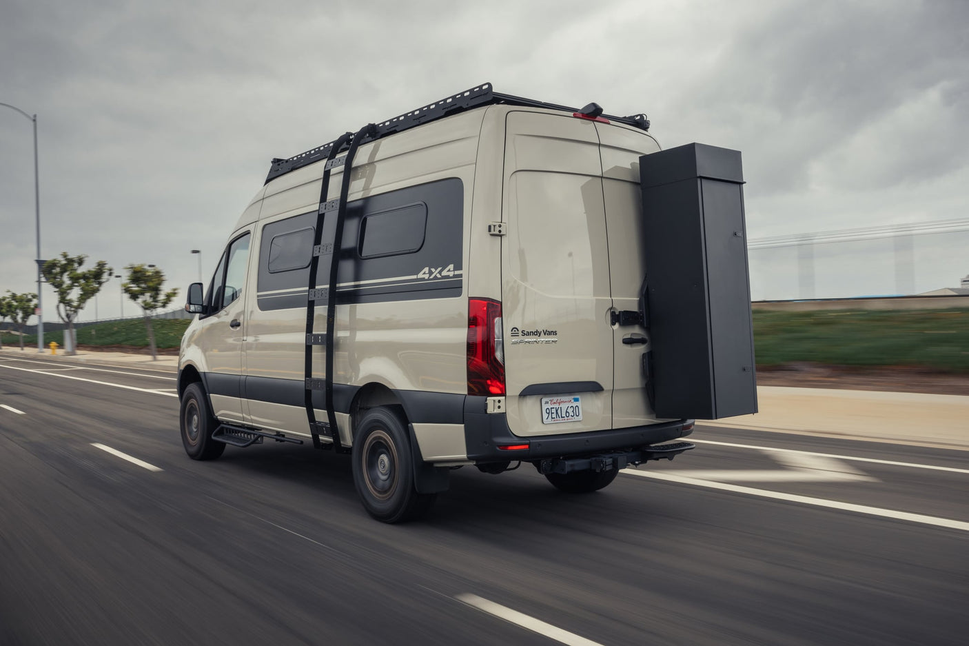 and ladder on a sandy coast.|Stylish RV rental: custom wood camper van interior with kitchen