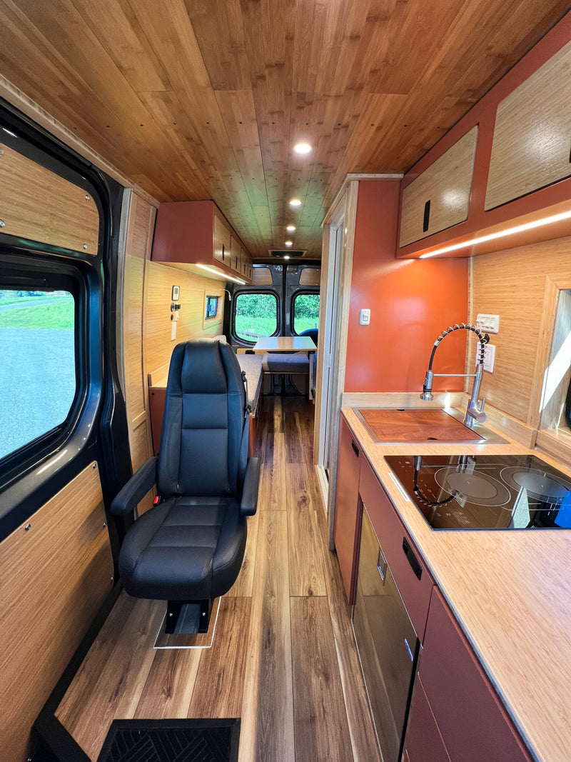  parked under clear skies.|Inside a sleek rv rental camper van — photo 5
