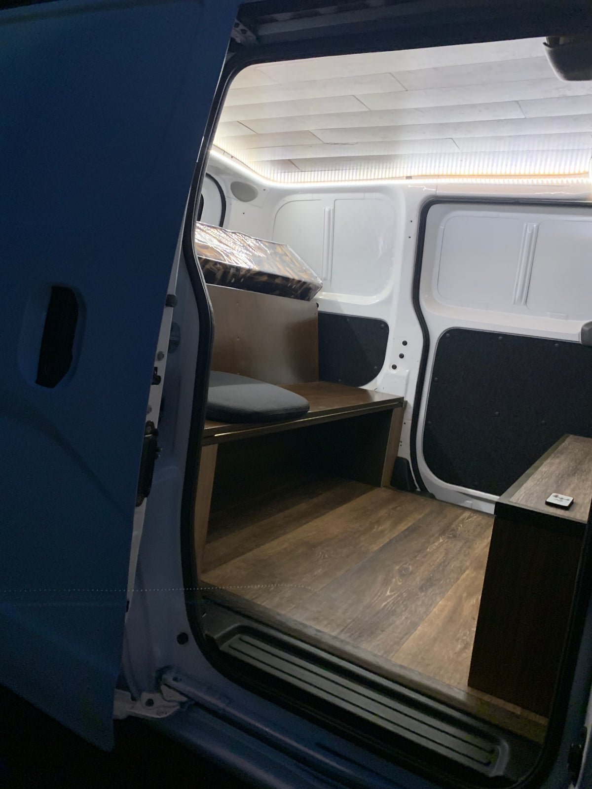  opening to a lush outdoor scene.|Interior of a custom **rv rental** camper van — photo 9