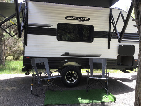 ready for adventure in nature.|Cozy rv rental setup: a white Sun Lite Sport travel trailer with an extended awning
