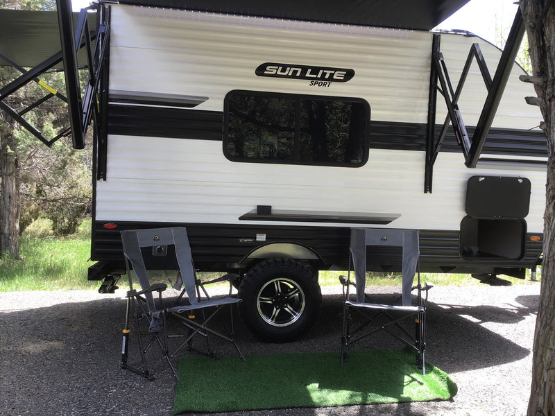  ready for adventure in nature.|Cozy rv rental setup: a white Sun Lite Sport travel trailer with an extended awning — photo 2