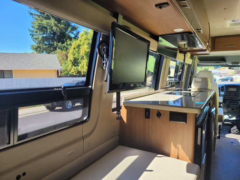  a compact kitchenette with a microwave and Norcold fridge.|Inside an RV rental — photo 13