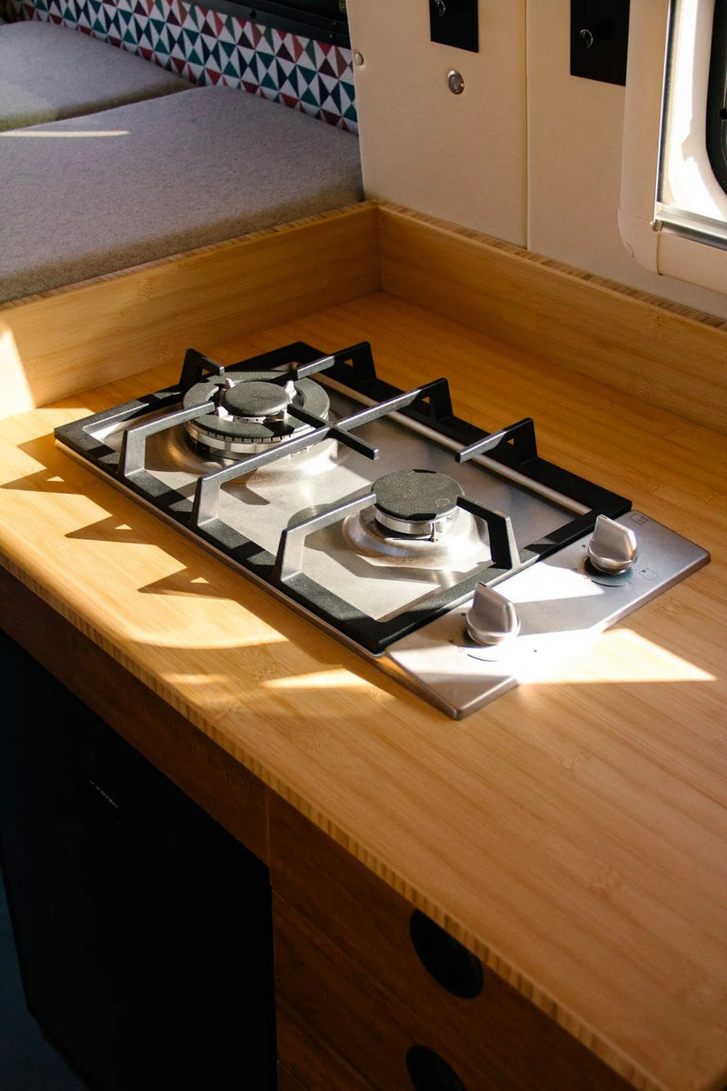  & geometric decor.|Inside a modern rv rental camper van: custom wood cabinets — photo 9