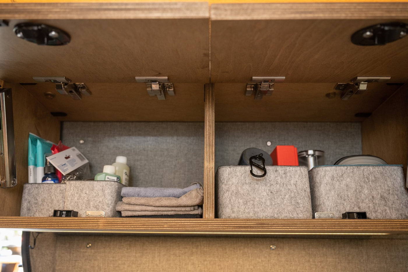 Efficient overhead storage in an RV rental: organized felt bins, toiletries, and travel essentials. — photo 15