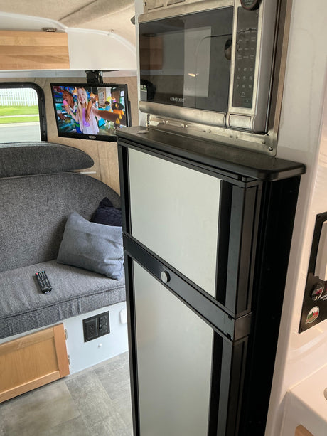  and rear camera.|A white Scamp travel trailer
