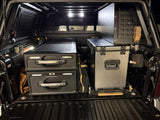  featuring stove & cookware. Ideal for an RV rental road trip.|RV rental ready: Overland pickup with open bed cap reveals organized camping kitchen (stove
