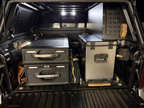  featuring stove & cookware. Ideal for an RV rental road trip.|RV rental ready: Overland pickup with open bed cap reveals organized camping kitchen (stove