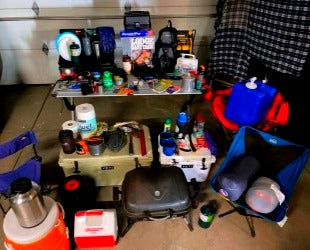 A comprehensive layout of camping and outdoor gear, perfect for an RV rental trip, includes coolers, grill, chairs, and water jugs. — photo 17
