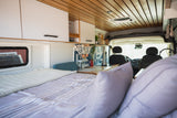 Experience van life in this stylish RV rental. Features a comfy bed, functional kitchen, and bright interior.