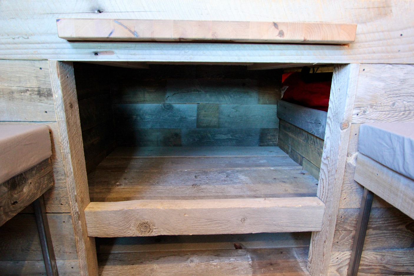 Rustic wood storage cubby built into an RV rental interior, highlighting the unique reclaimed wood textures.