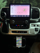 RV rental cockpit view: large infotainment screen with Apple CarPlay, smartphone in mount, and dashboard controls.