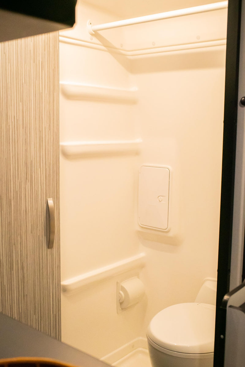  highlighting practical amenities.|RV rental interior: a chessboard on a table between comfortable black seats — photo 4