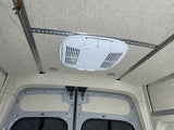 This RV rental interior features a clean fabric ceiling, versatile L-track rails, and a Dometic Belair 2800 AC unit.