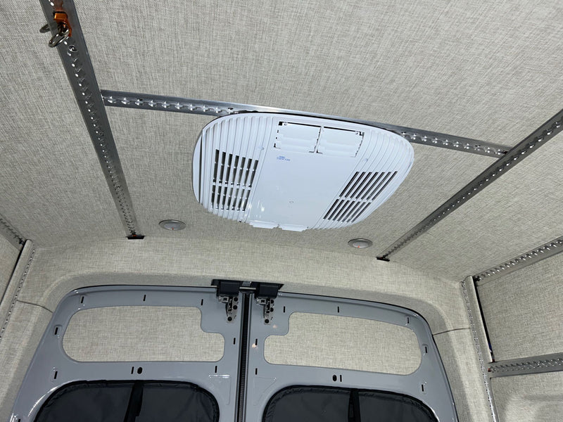  and spacious floor plan with cargo tracks.|RV rental: Van interior with a raised bed — photo 9