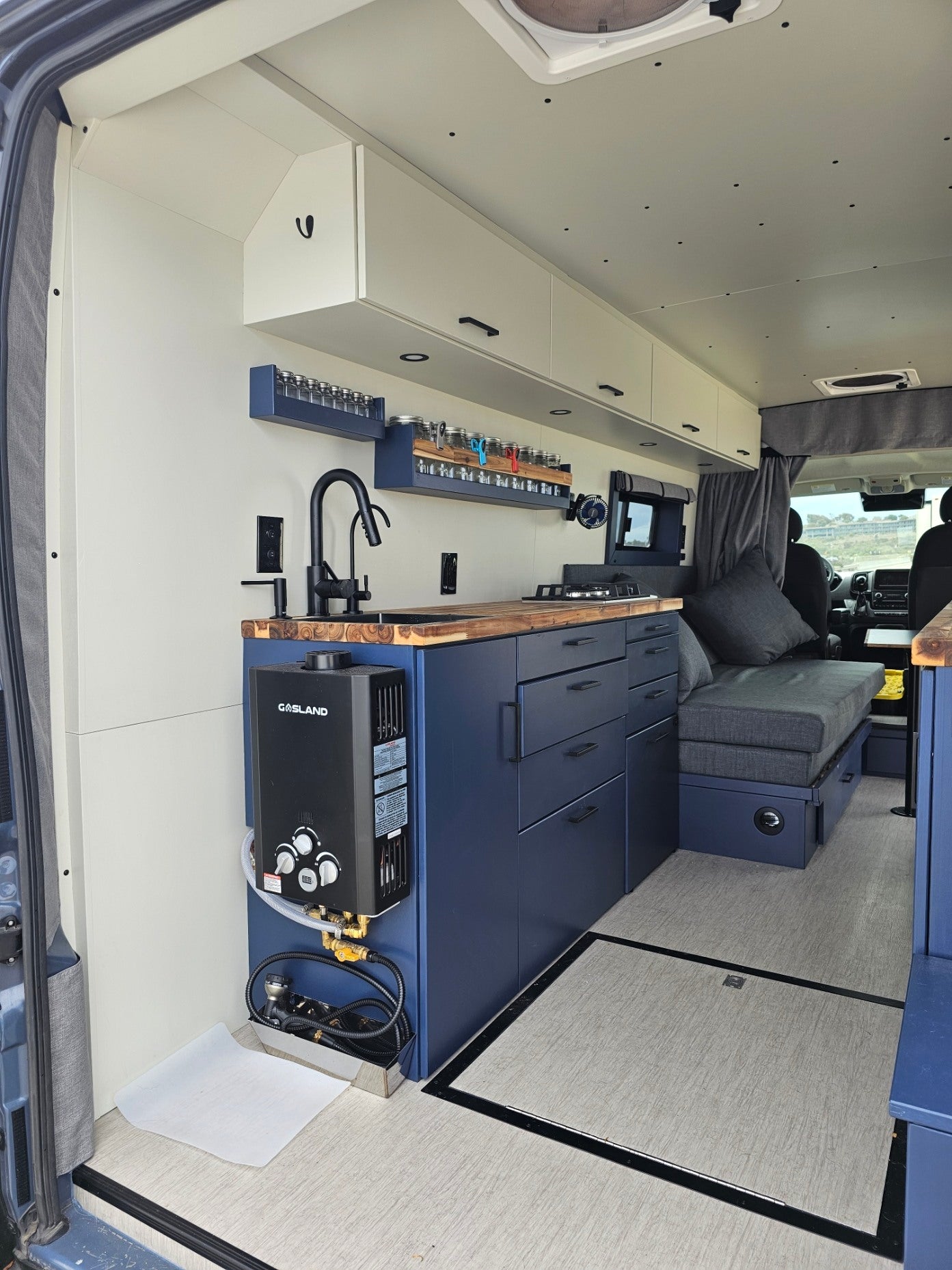 Explore this functional RV rental! Features a compact kitchen with hot water heater, ample storage, and comfy lounge.