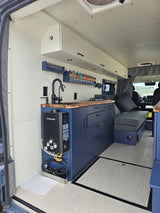 Explore this functional RV rental! Features a compact kitchen with hot water heater, ample storage, and comfy lounge.