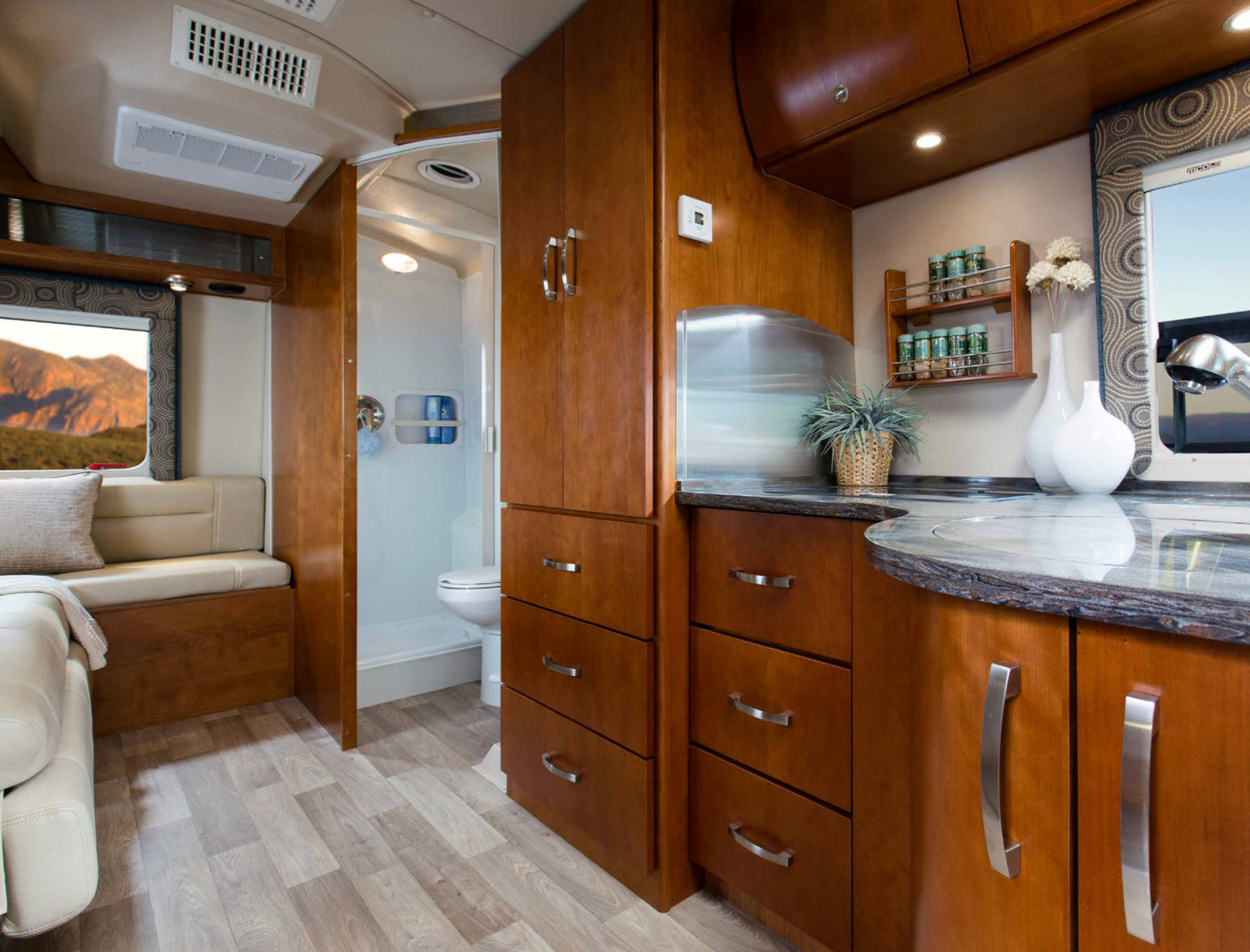 Inside this rv rental: a well-appointed kitchen, comfortable living area with a scenic window, and practical bathroom.
