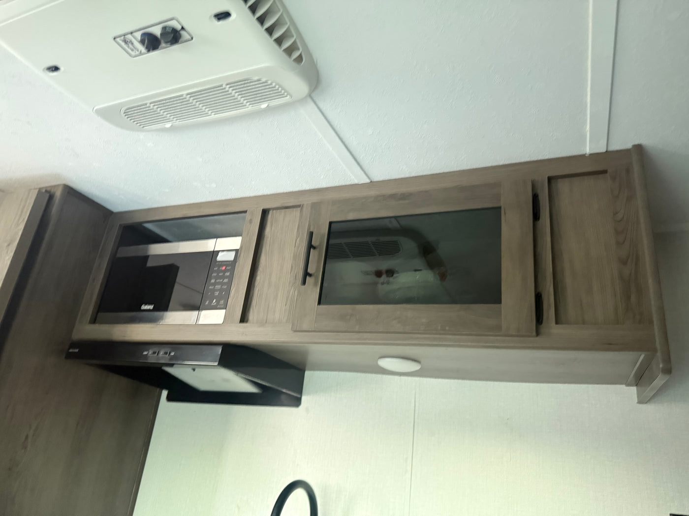  perfect for meals on the go. Features comfortable seating and a pretty table setup.|Compact RV rental kitchen featuring a marble-look counter — photo 7