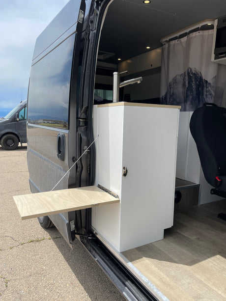 Explore with this RV rental! Modern van conversion features a compact kitchen sink & fold-down exterior table.