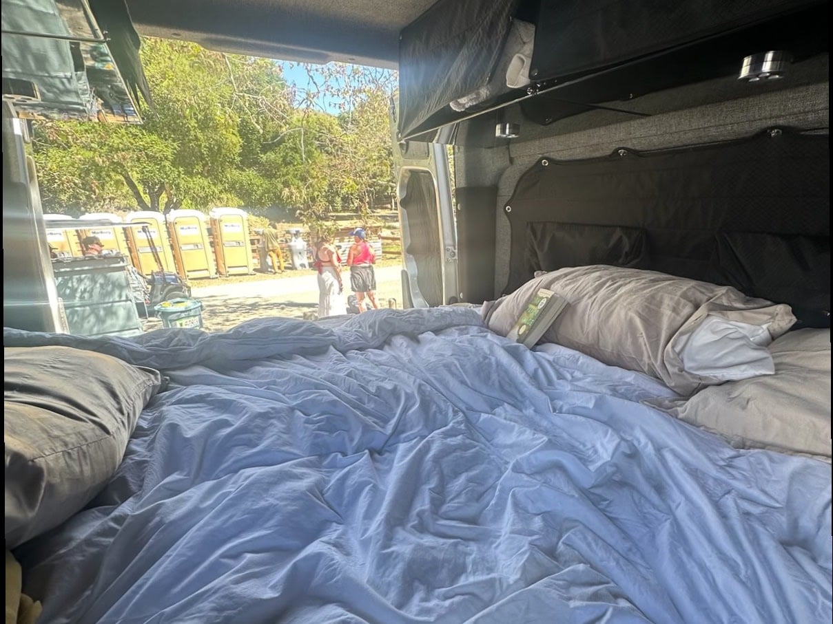  ready for your next adventure.|Young boy gives thumbs-up at a sunny campsite with a silver RV rental