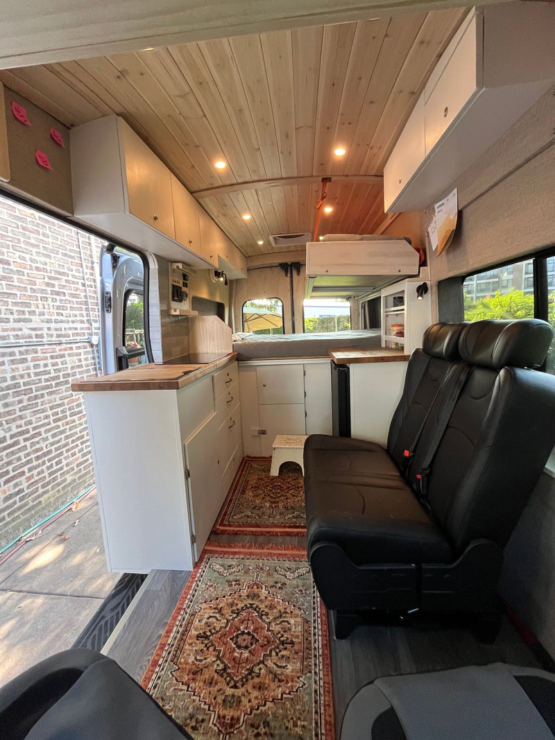  amidst scenic mountains.|RV rental: Inside a modern converted camper van with a wood ceiling — photo 2