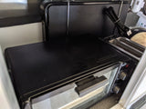 Compact cooking appliances in an RV rental, featuring a black toaster oven and a slot toaster.