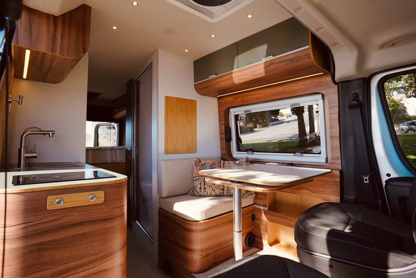Step inside this stylish RV rental! Features a modern kitchen, dining area, and warm wood accents.