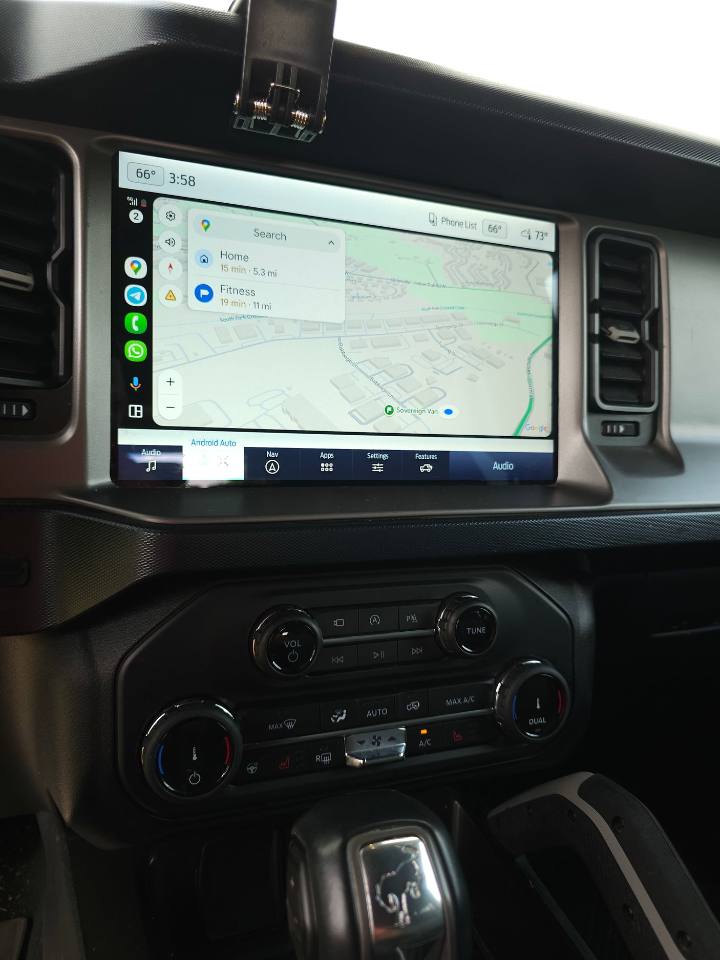 Ford Bronco interior: Android Auto navigation to "Sovereign Van", suggesting an RV rental pickup. Modern infotainment.