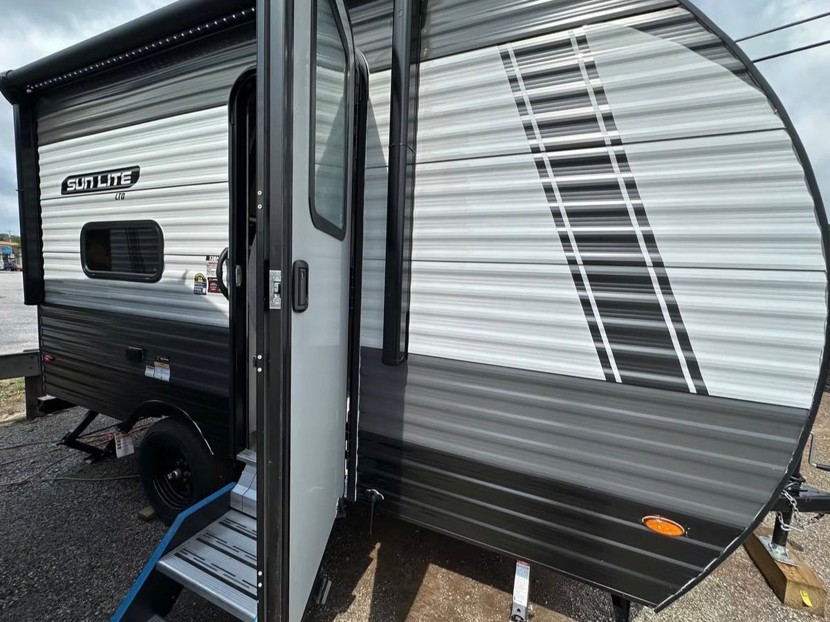 ideal for an RV rental. Propane tank visible for camping adventures.|Grey & black travel trailer RV rental — photo 3
