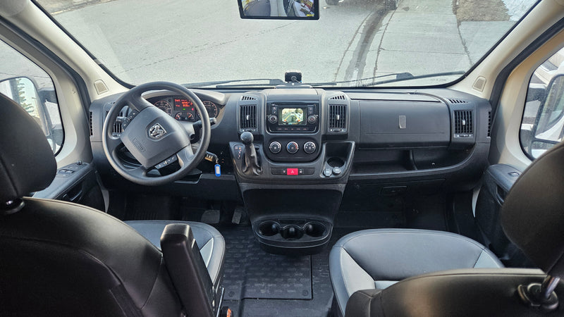 Inside an RV rental: Driver's cockpit with dashboard, steering wheel, and seats visible, ready for adventure. — photo 8