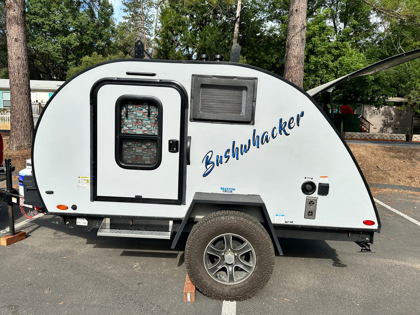 Explore the outdoors with this Bushwhacker teardrop RV rental, featuring off-road tires and ready for camping adventures.