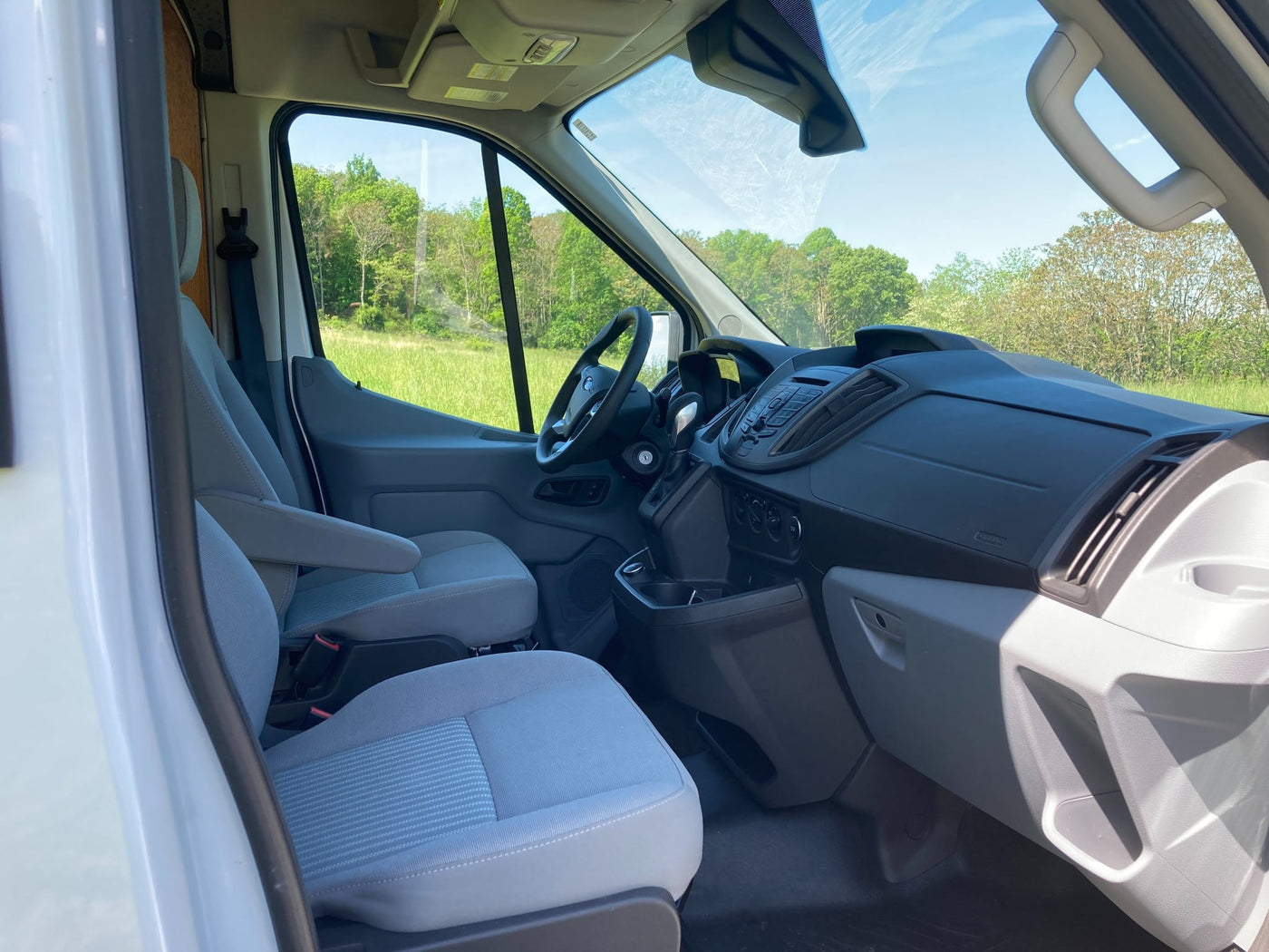  and wood interior for your adventure.|Custom RV rental van with open back doors revealing bunk beds — photo 7