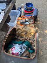 Bagged camping kitchen setup for your RV rental, with cooking utensils, dishes, and sauces ready for outdoor meals.