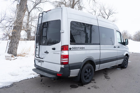 Silver Mercedes Sprinter camper van for rv rental, parked in snow. Ideal for winter travel and off-grid adventures.