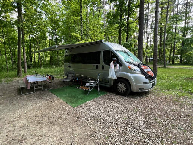  showcasing vibrant red and orange skies.|Cozy rv rental camper van camping setup with an awning