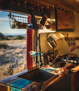 Cozy RV rental kitchen with a scenic view, perfect for cooking delicious meals while exploring the outdoors.