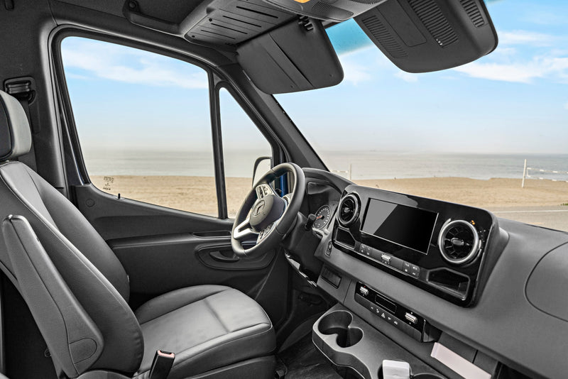 Interior of a spacious RV rental van with a view of a serene beach from the driver's perspective. — photo 4