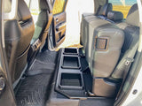 Rear interior of a clean vehicle: black leather seats, WeatherTech floor mats, and a custom floor storage system. Great for RV rental use.