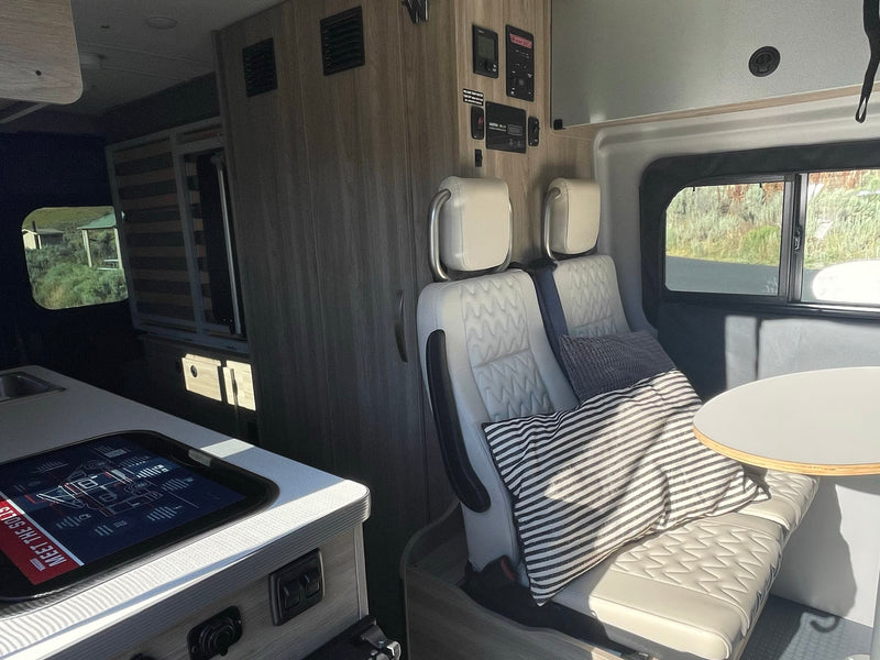  and flexible seating areas.|Experience adventure in this RV rental: a modern camper van interior with a functional kitchen — photo 5