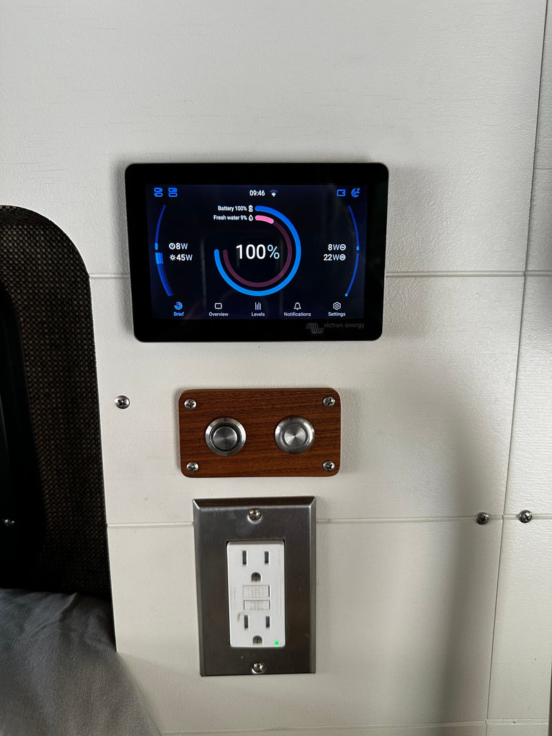 RV rental control panel shows battery 100%, fresh water 9%, 09:46 time, with physical buttons and an outlet below. — photo 17